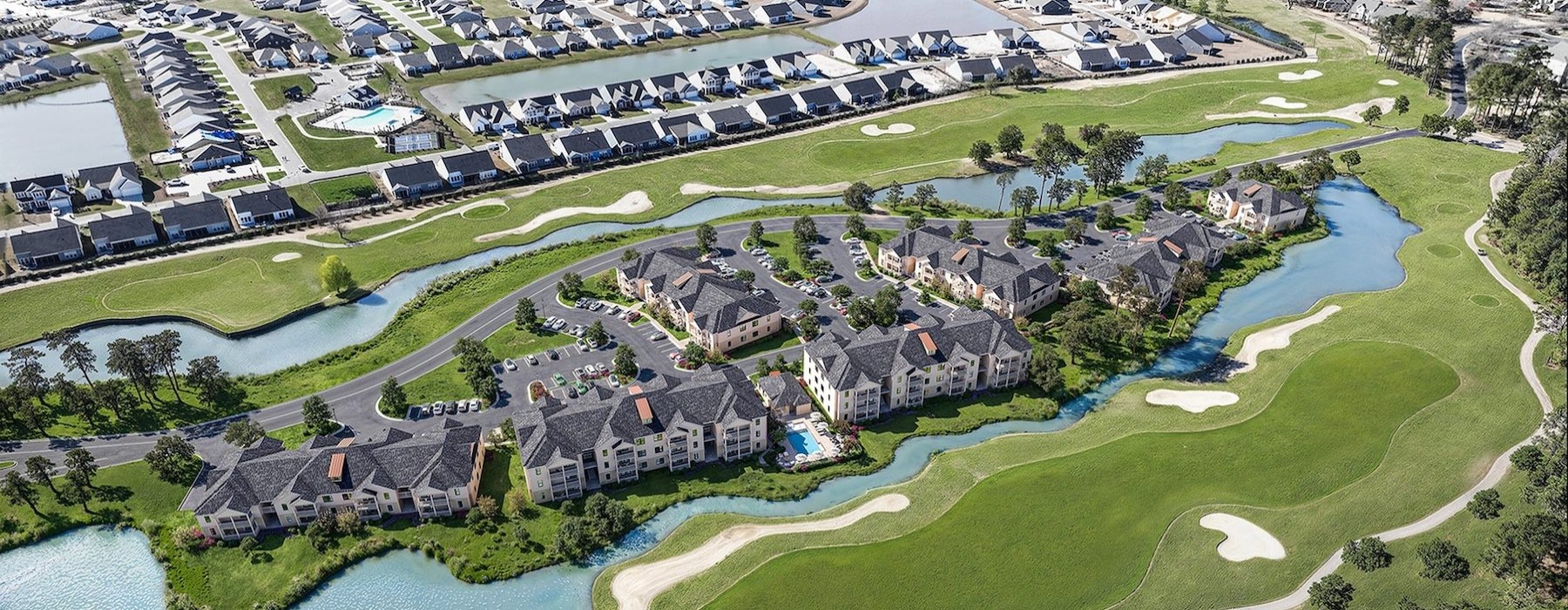a large property surrounded by water and a golf course