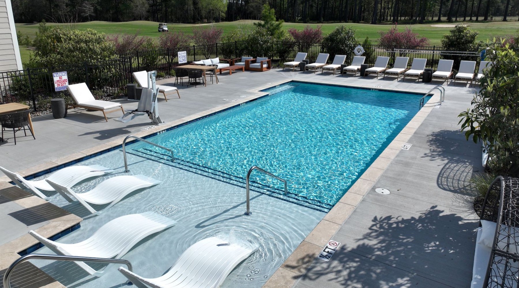 a swimming pool with lounge chairs