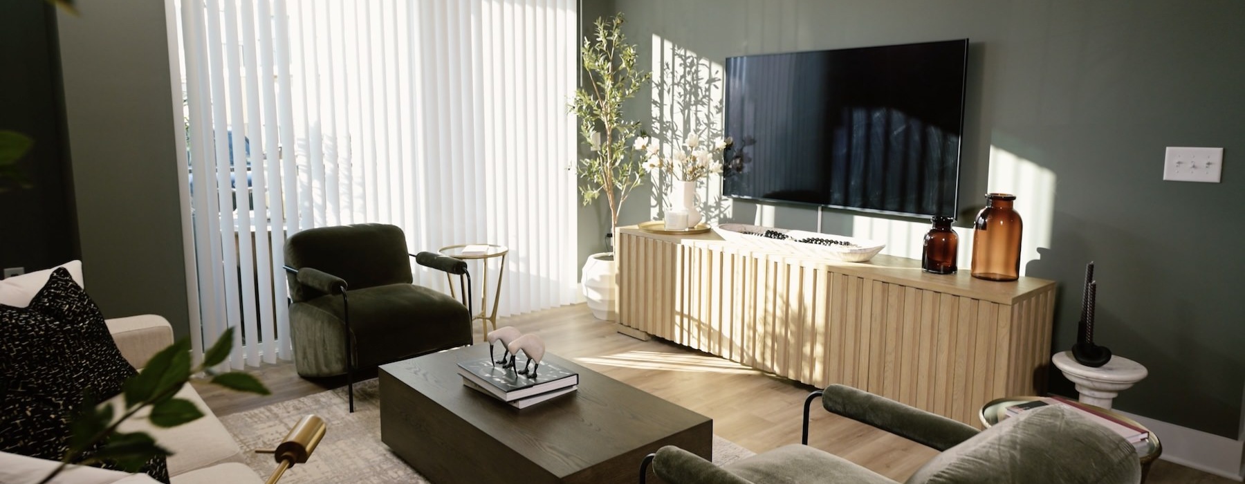 a living room with a tv and chairs