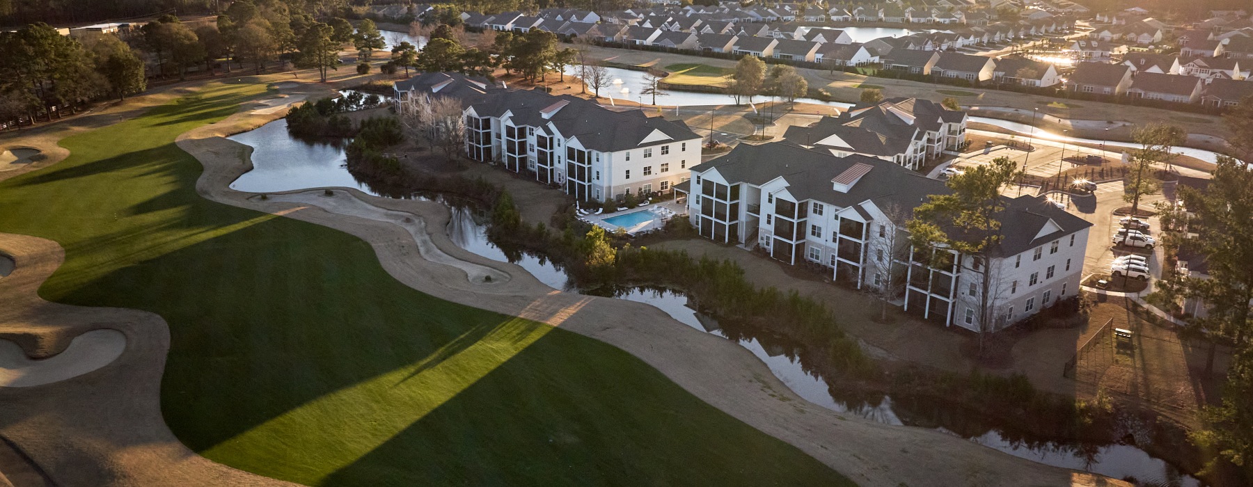 Aerial view of golf course and The View at Crow Creek Apartments