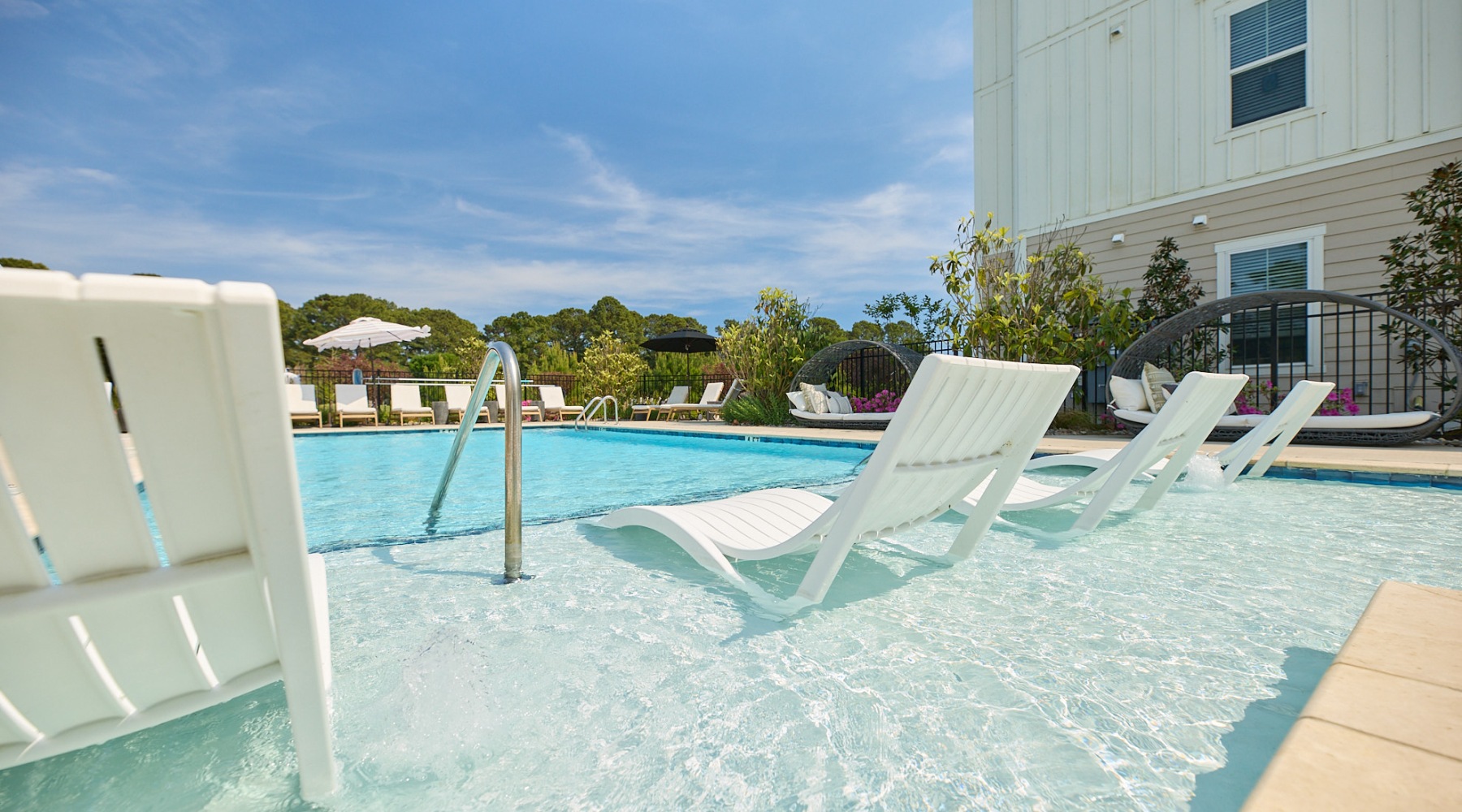 a swimming pool with lounge chairs