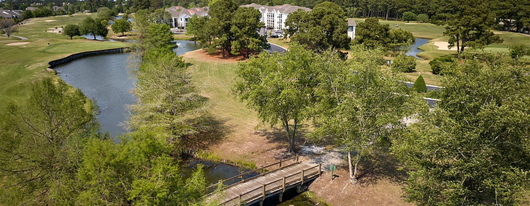 Aerial view of golf course and The View at Crow Creek Apartments