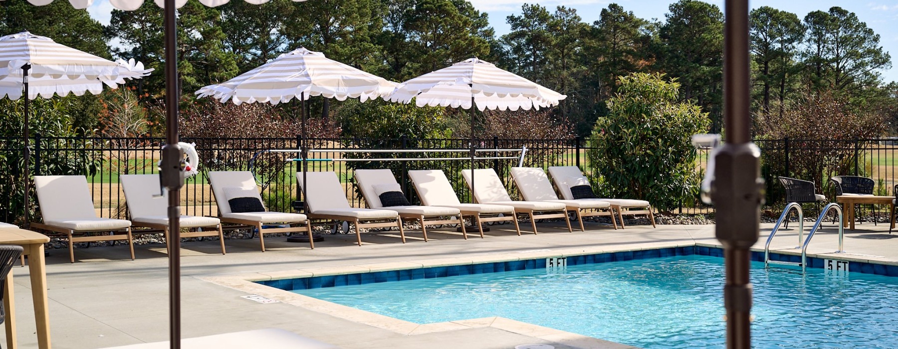Resort-style swimming pool with lounge seating